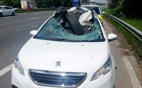 Lốp xe tải lăn tự do phá nát mui xe, tài xế thoát chết một cách thần kỳ