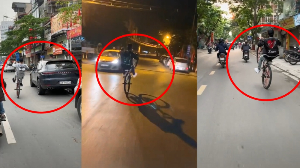 Nam thanh niên điều khiển xe đạp bằng 1 bánh trên đường phố Hà Nội