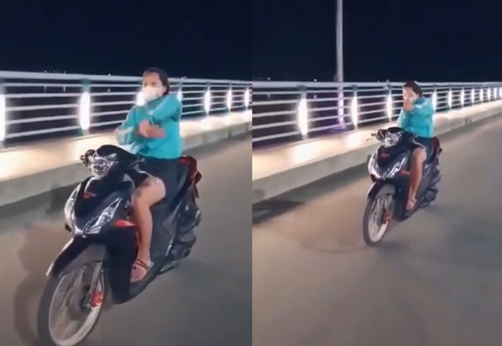 Cô gái thả hai tay để múa quạt và bắn tim trên cầu Thạch Bích Cô gái thả hai tay để múa quạt và bắn tim trên cầu Thạch Bích