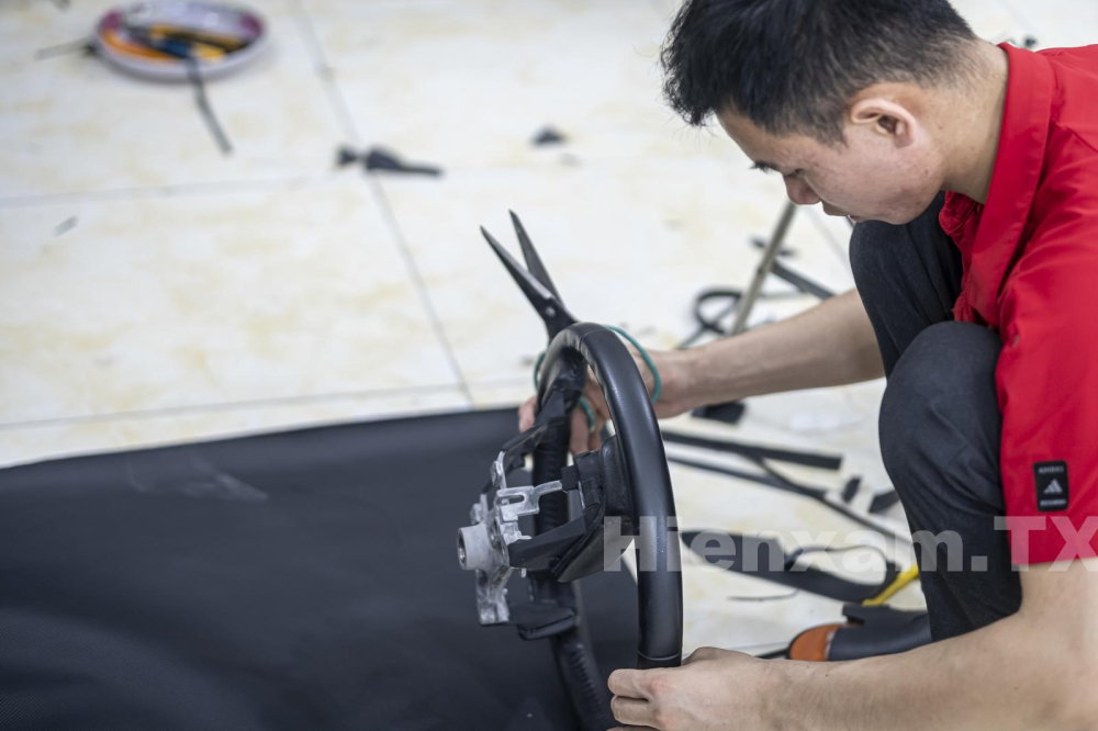 Measure the size of the leather to prepare for covering the steering wheel.