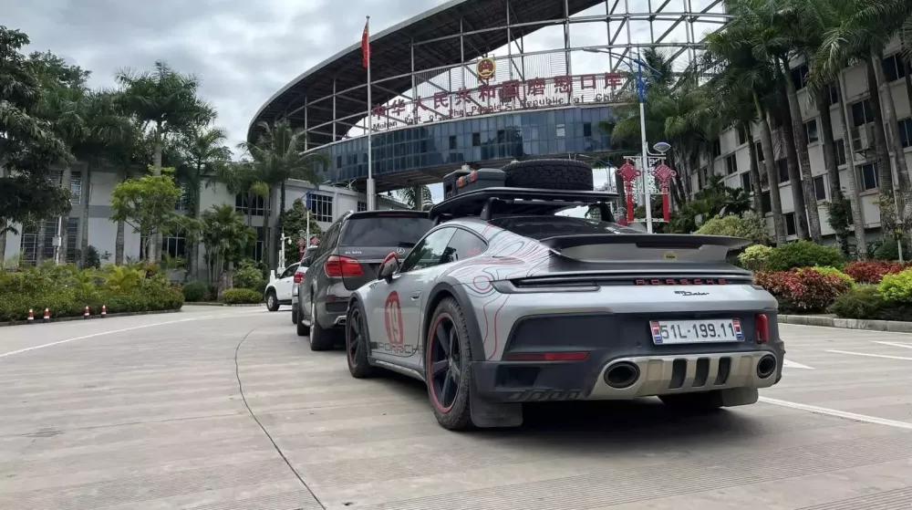 The Porsche 911 Dakar in front of a scenic backdrop