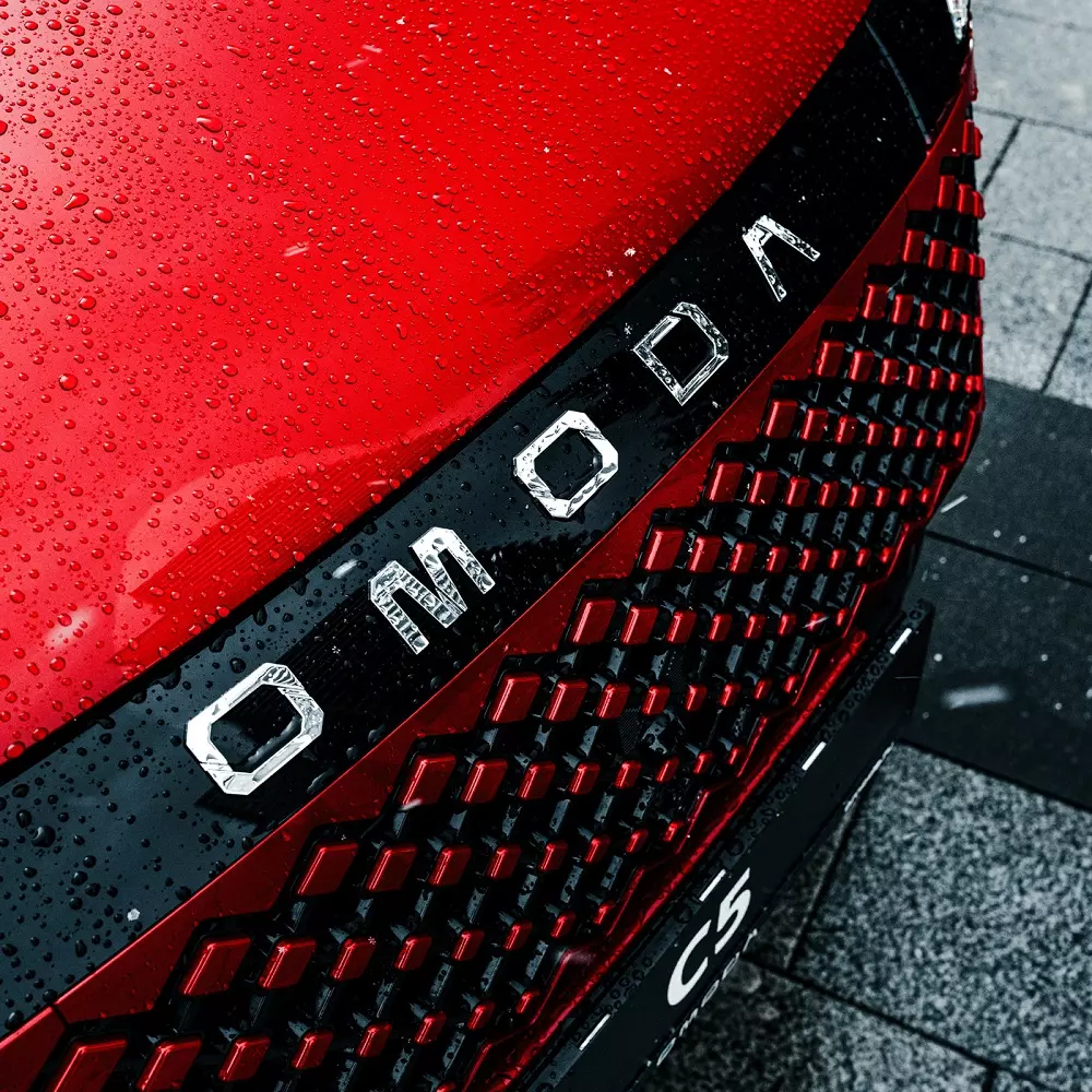 Nẹp màu đen với dòng chữ Omoda mạ crôm nằm phía trên lưới tản nhiệt của C5 mới Nẹp màu đen với dòng chữ Omoda mạ crôm nằm phía trên lưới tản nhiệt của C5 mới